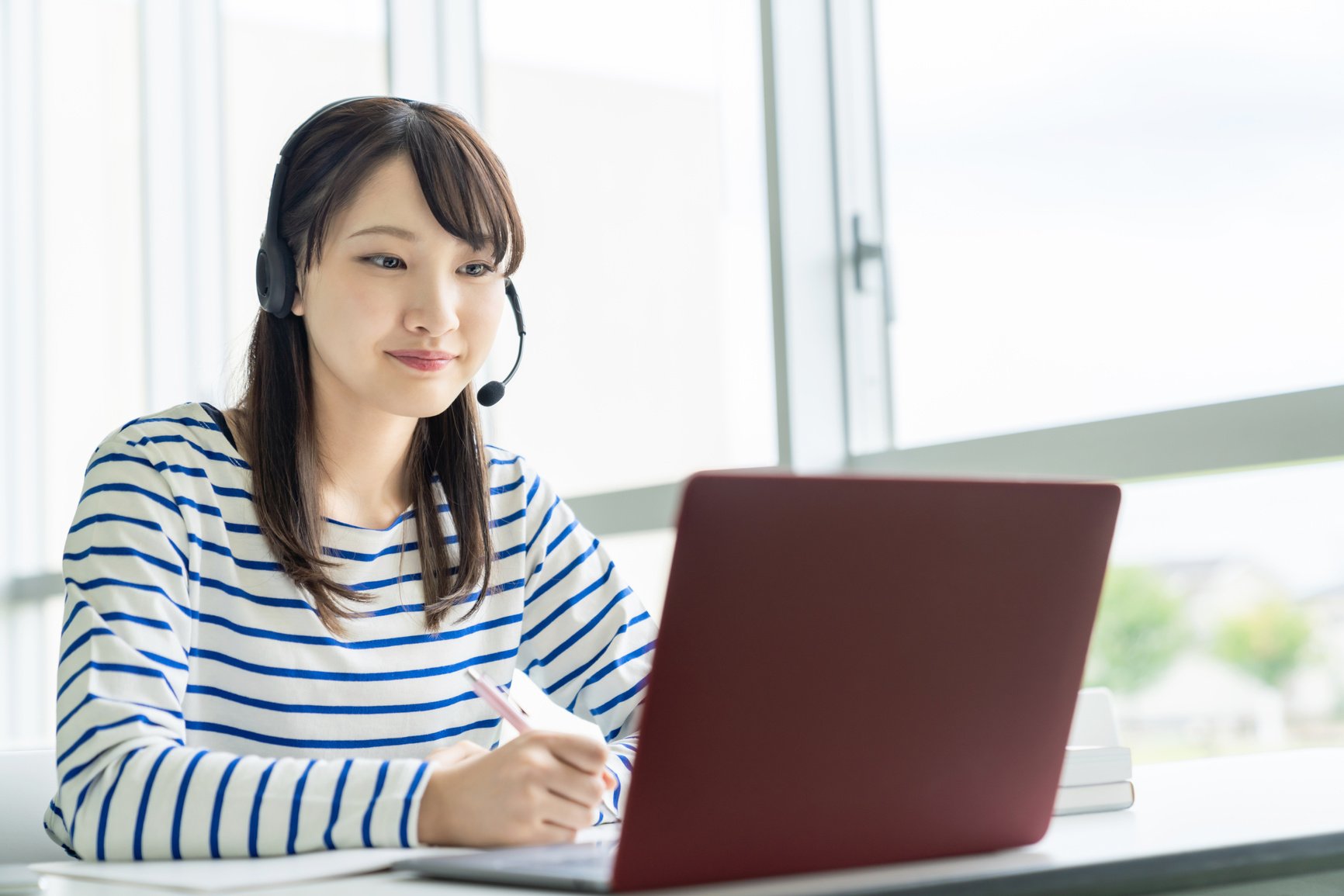 Young asian female student taking online lessons.